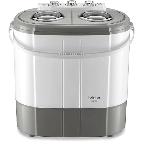 Mini lave-linge portable gris et blanc à deux compartiments dans une buanderie lumineuse